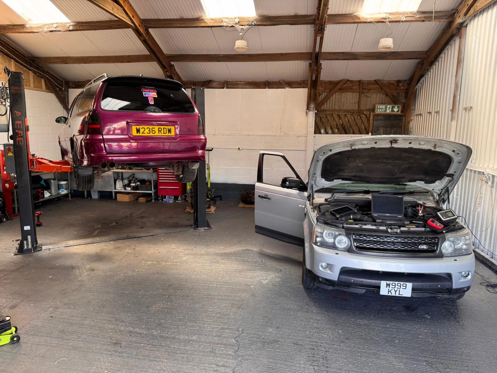 Vehicles being repaired inside Clark’s Garage workshop